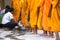 An Giang, Vietnam - Dec 6, 2016: Queue of barefoot monks with foot wash ceremonial in south of Vietnam