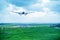 Giant aircraft landing at the airport with runway in the background. Back view