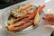 Giant Alaska King Snow crab legs grilled on silver plate