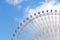 Giant amusement funfair ferris wheel on blue sky
