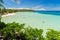 Giant beach of white sand under blue tropical sky