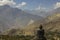 A giant black buddha on top of a mountain observes a Nepali valley very close to Muktinath in the Nepali Himalayas