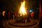 Giant bon fire lit for the festival of Lohri surrounded by people