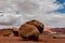 Giant boulders shown with human cars for comparison by the side of the highway, Vermillion cliff range, Page, AZ, USA