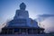 Giant Buddha statue on top of tropical island mountain in asia