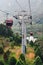 Giant cable posts of Gondola lifts place amid green trees in the area of Sun Moon Lake Ropeway in Yuchi Township, Nantou County