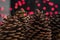 Giant Christmas pinecones Jeffrey Pine Cones in front of red bokeh Christmas Lights