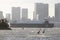 giant container ship pass through the channel of tokyo bay near Odaiba