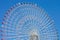 Giant ferris wheel with blue sky.