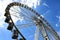 Giant ferris wheel detail. white gondolas. blue sky.