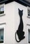 Giant figure of black cat on a white wall in Altena