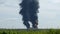 A giant fire and a column of black smoke after the explosion at the oil storage