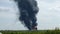 A giant fire and a column of black smoke after the explosion at the oil storage.