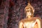 Giant golden Buddha statue front Thai acient art living style in Buddhist temple., Bangkok, Thailand