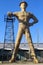 Giant Golden Driller Statue and landmark of oilfield worker and oil derrick near Route 66 in Tulsa Oklahoma