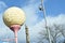 Giant Golf Ball Shaped Sign On Street Post