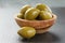 Giant green olives in olive bowl on slate