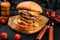 Giant hamburger fast food cutlet on wooden board