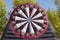 Giant inflatable dart board with velcro ball in autumn park