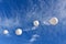 A giant inflatable white advertising balloon floats in the sunny blue sky