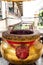 Giant joss stick pot with red incense stick at Chinese temple