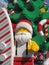 Giant Lego Santa in front of a Christmas tree and a surfboard