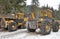 Giant logging vehicles in the winter forest