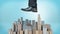 A giant male shoe ready to stomp at a small cluster of business towers on blue background.