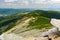 Giant Mountains, mountain panorama from the hiking trail to the top of Sniezka. View of the vast mountain slopes and trails