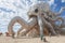 Giant Octopus Sculpture on Sandy Beach, An oversized playground in a land of giants, AI Generated