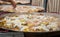 Giant paella is cooked in huge frying pans for a rural fair.