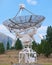 Giant parabolic antenna looking into blue sky