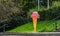 A giant plastic ice cream and cone by an ice cream stand