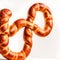 Giant Pretzel Oktoberfest Day covered in coarse salt and glistening with melted butter, in white Background. Ai Generated image