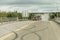 Giant red dump truck makes way down to the trans canada on road with tire markings