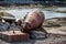 Giant rusty metal buoy near the ocean