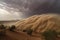 giant sandstorm, with swirling clouds of dust and debris, engulfing a desert landscape