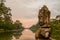 Giant sculpture face with lake at the bacground with sunset