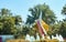 Giant seashell fountain in front of palm tree and foliage