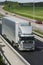 Giant silver-gray lorry in countryside