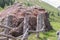 Giant stone boulder on a pasture and destroyed wooden fence, Austria