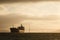 Giant tanker ship leaves golden gate bridge behind heading to sea at sunset