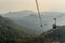 Giant Tian Tan Buddha statue on the peak of the mountain, view from Ngong Ping 360 cable car at Po Lin Monastery in Lantau Island,