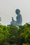 Giant Tian Tan Buddha statue on the peak of the mountain, view from Ngong Ping 360 cable car at Po Lin Monastery in Lantau Island,