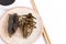 Giant Water Bug is edible insect for eating as food Insects deep-fried crispy snack on plate and sauce with chopsticks on white