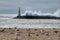 Giant waves breaking on the breakwater and the lighthouse