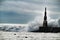 Giant waves breaking on the breakwater and the lighthouse