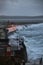 Giant waves and violent storm jumping over the pier in the seaside town of Tramore, Waterford, Ireland. vertical format