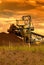 A giant wheel excavator in brown coal mine at sunset