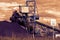 A giant wheel excavator in brown coal mine in the sunset